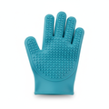 Silicone pet grooming glove removing loose fur from dog and cat